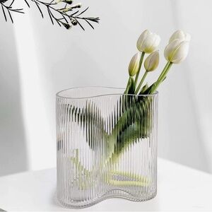 Iittala Alvar Aalto clear glass vase with vertical ribbing.